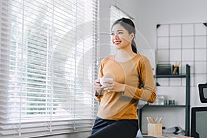 Contemplative businesswoman professional on a coffee break during remote working at home office.