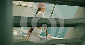 A contemplative glance of tourist from the boat at the sea. Woman gazes on ocean vastness, tranquility of the marine.