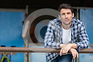 contemplative man at equestrian stables