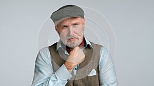 Contemplative man in his 50s with beard, thoughtful gaze in black trilby