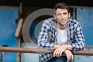 contemplative man at riding stables