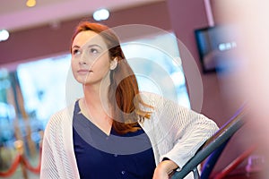 contemplative woman in cinema lobby