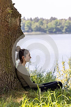 Contemplative Woman Enjoying Solitude by the Lake Shore