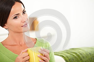 Contemplative woman sitting in the house