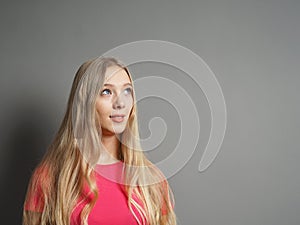 Contemplative young woman looking up towards copy space