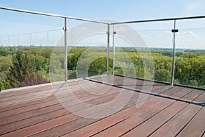 Contemporary architecture apartment balcony view with exotic cumaru wood grooved decking and glass railing