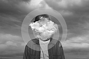 Contemporary art collage. Black and white, Male body of model with head full of smoke about sky and clouds.