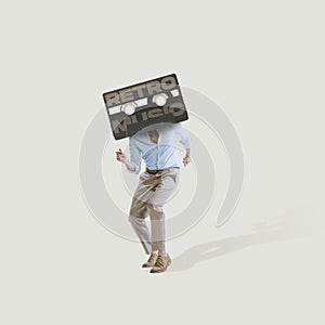Contemporary art collage. Man in official cloth with retro music cassette dancing isolated over light gray background