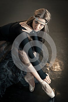 Contemporary ballet dancer on a wooden chair on a repetition