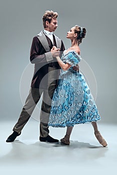 Contemporary ballroom dancers on grey studio background