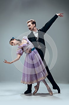 Contemporary ballroom dancers on grey studio background