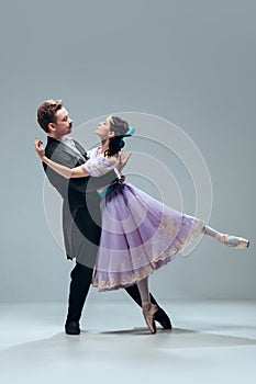 Contemporary ballroom dancers on grey studio background