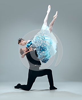 Contemporary ballroom dancers on grey studio background
