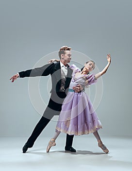 Contemporary ballroom dancers on grey studio background