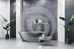 Contemporary bathroom with black stone tiles and standalone bathtub.