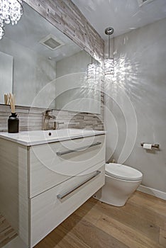 Contemporary bathroom design with taupe linear tiles accent wall photo