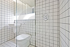 Contemporary bathroom with retro white tiled walls