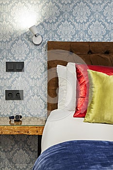 contemporary bedroom upholstered headboard detail with clock resting on the ledge