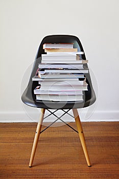 Contemporary black dining chair with stack of books