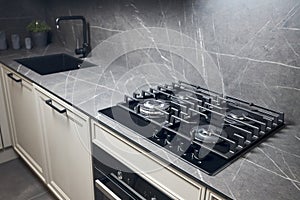 Contemporary black tempered glass gas stove hob with four burners with auto ignition knob cast iron pan supports fan