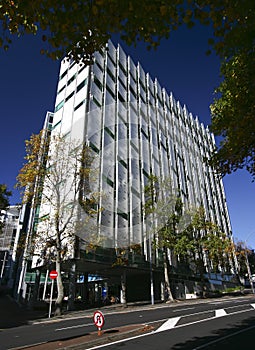 Serrated facade with peeling off perforated panels on Business School on street, Auckland University of Technology, New Zealand photo