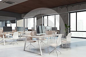 Contemporary coworking office interior with furniture, windows and equipment.