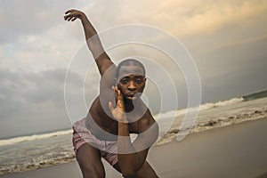 Contemporary dance choreographer and dancer doing ballet beach workout . a young attractive and athletic black African American