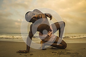 Contemporary dance choreographer and dancer doing ballet beach workout . a young attractive and athletic black African American