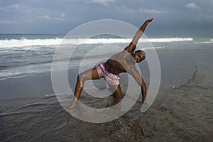 Contemporary dance choreographer and dancer doing ballet beach workout . a young attractive and athletic black African American