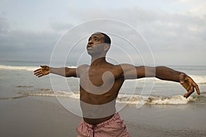 Contemporary dance choreographer and dancer doing ballet beach workout . a young attractive and athletic black African American