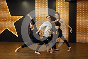 Contemporary dance performers posing in studio