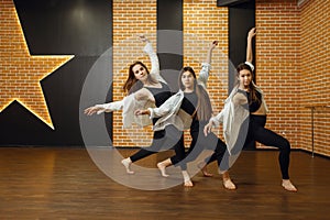 Contemporary dance performers posing in studio