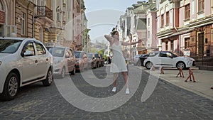 Contemporary dancer girl Caucasian 20 years dancing on the street. light woman dancing energetically on the street