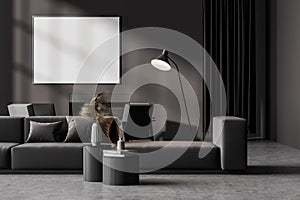 Contemporary dark grey living room interior with fireplace, sofa, armchairs. Big poster template mockup on wall