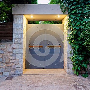 Contemporary design house entrance metallic gray door, illuminated