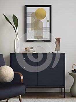 Contemporary design of living room interior with mock up poster frame, blue velvet armchair, elegant commode, beige carpet, leaf