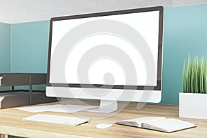 Contemporary designer desktop with empty white computer screen