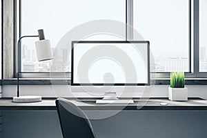 Contemporary desktop with empty white computer screen