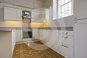 Contemporary fully fitted kitchen in beige