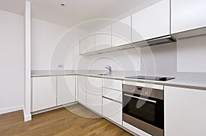 Contemporary fully fitted kitchen in white photo