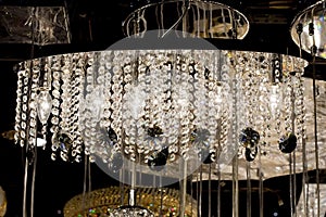 Contemporary glass chandelier isolated over black background