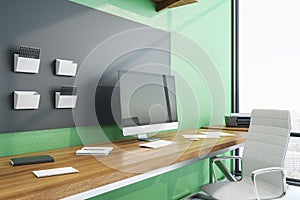Contemporary green workplace with Ñomputer on table