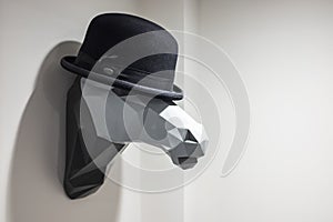 Contemporary horse shape hat holder with a black bowler hat