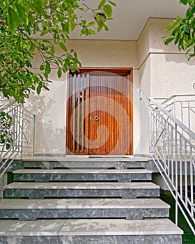 Contemporary house entrance brown wooden door, Athens Greece