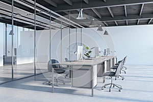 Contemporary industrial coworking office interior with glass, furniture and daylight.