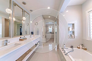 Contemporary luxury bathroom with lighting fixtures in all white