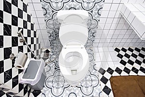 Modern bathroom design featuring artistic wall patterns and checkerboard tiles.