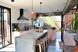 Contemporary modern kitchen interior in shady rose pink colors and concrete details.