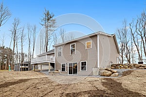 Contemporary and modern ranch-style house in the countryside with a gabled roofline and a porch