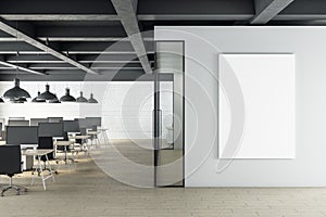 Contemporary office space with blank poster on wall